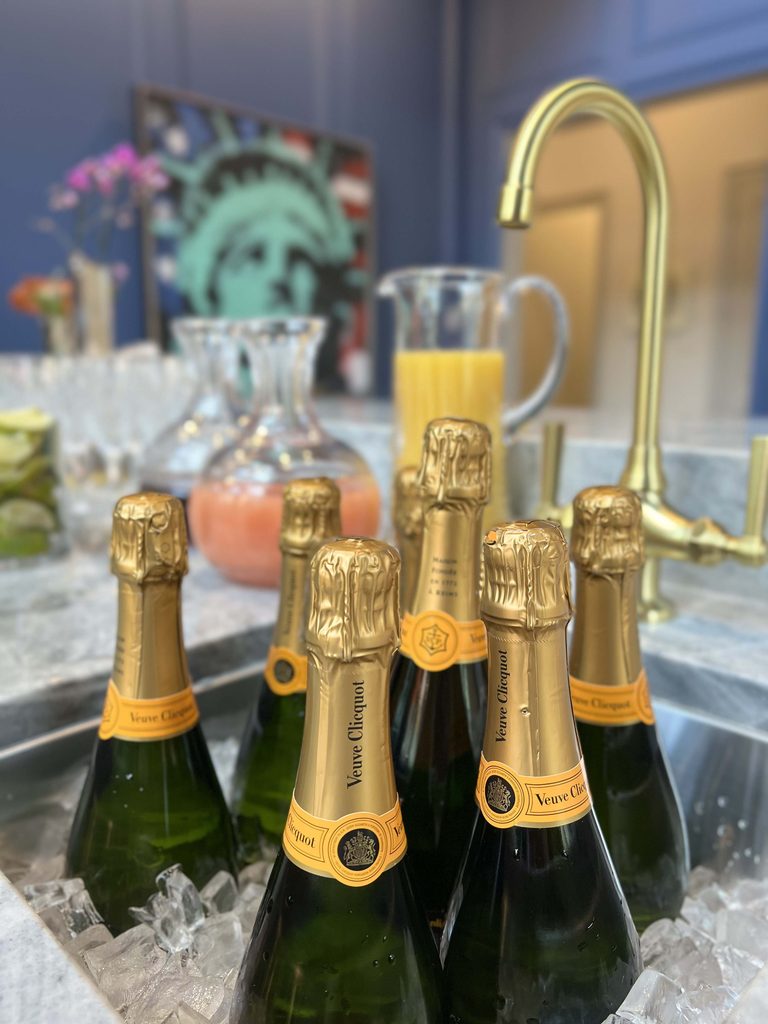 Champagne bottles on ice at a home bar