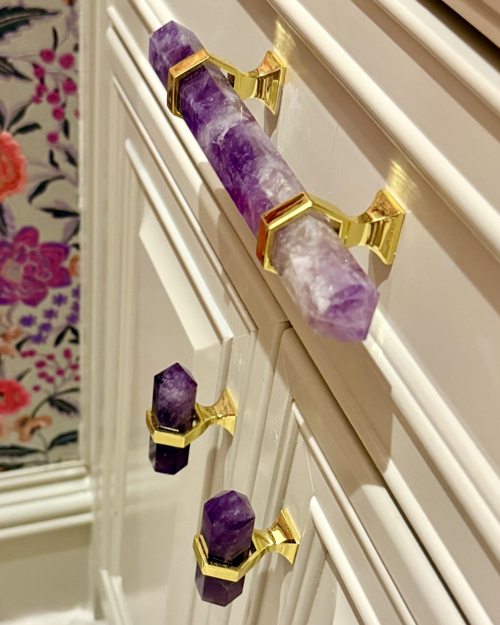 Amethyst cabinet pulls with gold hardware on cream cabinetry